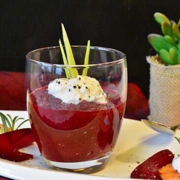 Appetizers glasses with beets, fresh goat’s cheese, hazelnut powder